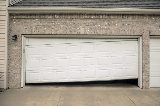 Professional maintenance work on a heavy-duty commercial garage door.