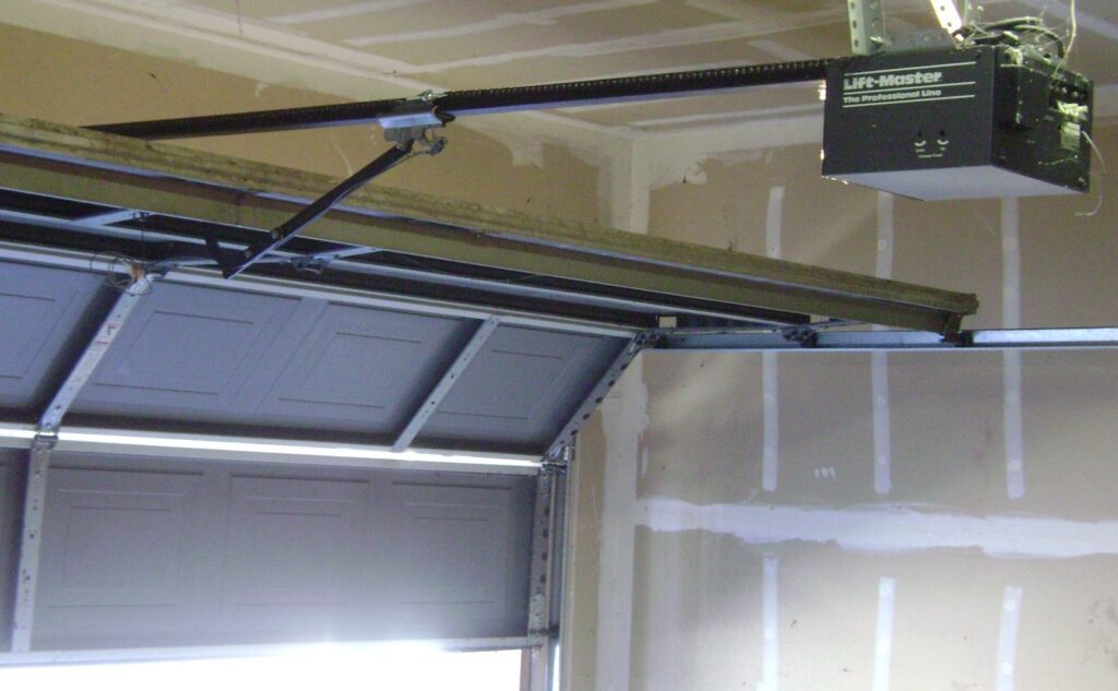 A garage door is being opened from the inside of a garage