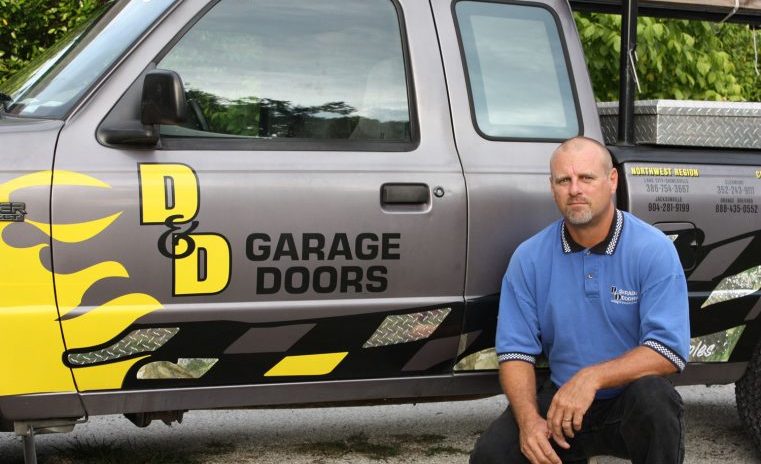 Professional maintenance work on a heavy-duty commercial garage door.