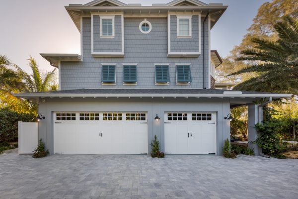 A three-car garage on a large, gray home