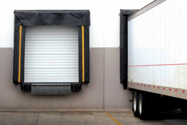 Professional maintenance work on a heavy-duty commercial garage door.