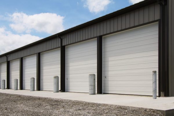 Several commercial garage doors on a building.