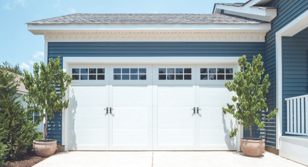 Two-car garage with white, carriage-style doors