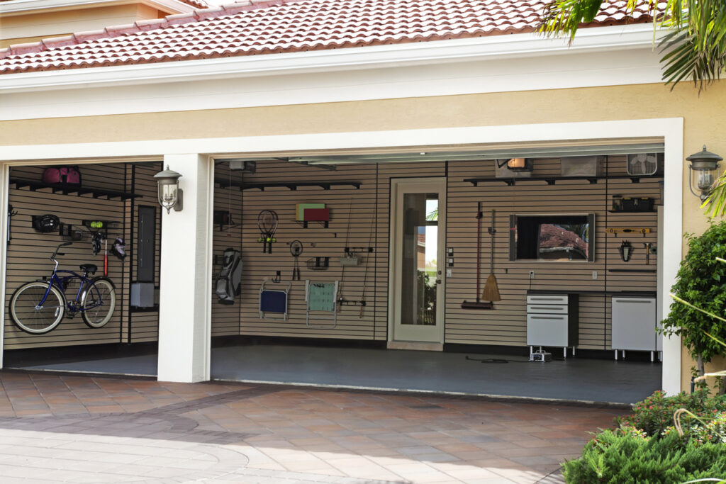 Well-organized two-car garage, view from outside, with both garage doors open.