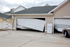 Badly damaged white garage doors after Hurricane Sandy